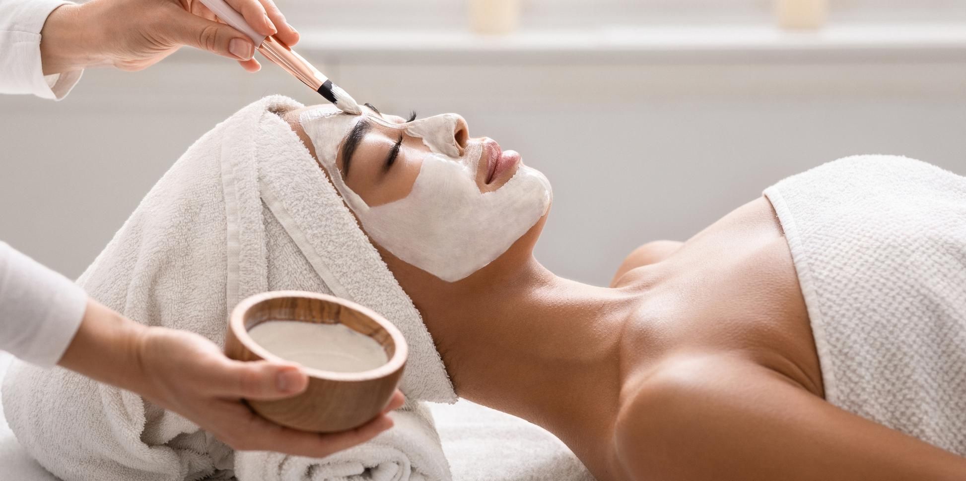 Facial treatment being applied with a brush.
