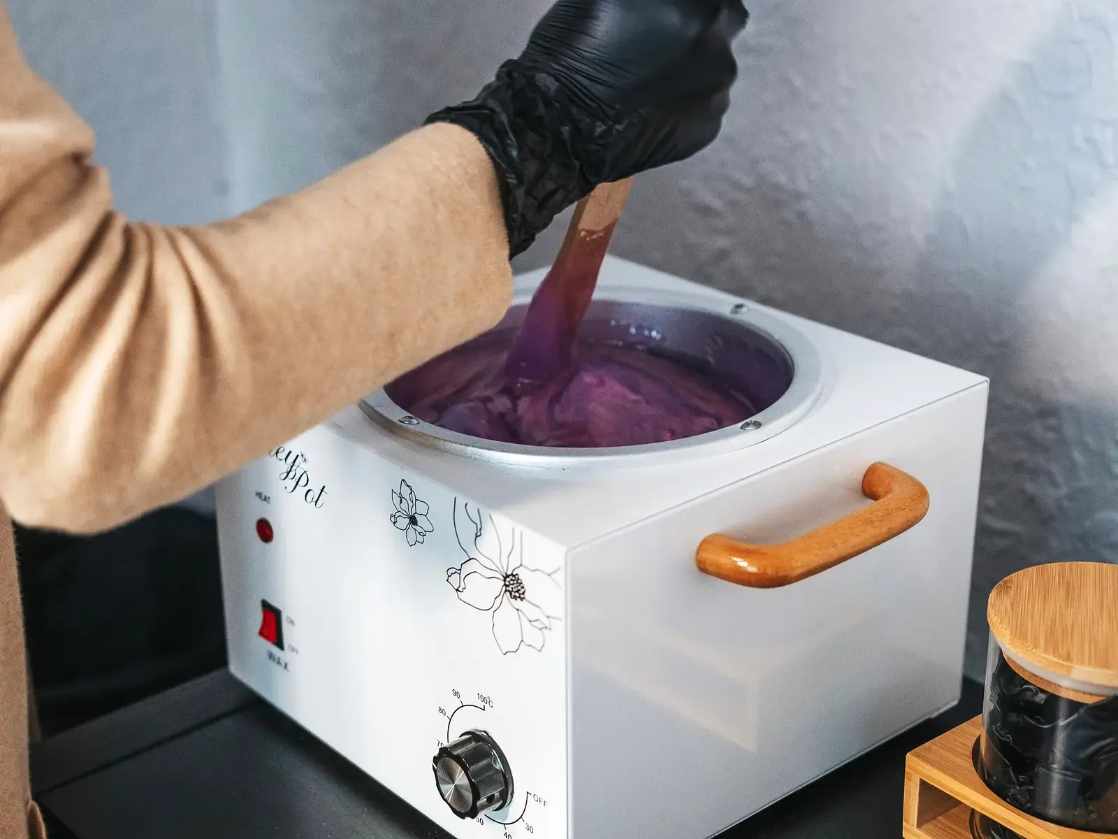 Professional hard wax being prepared in a salon wax warmer